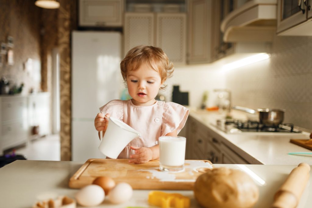 girl pours milk into a glass pastry preparation 2022 02 02 04 49 32 utc 1024x684