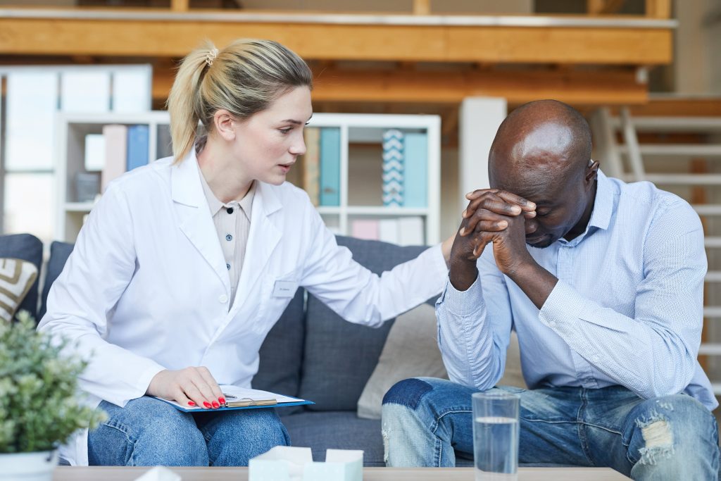 A client being comforted by a therapist in a Partial Hospitalization Program in West Palm Beach Rehab